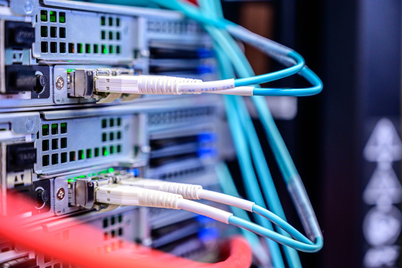 Home Detailed shot of Ethernet cables connected to server ports highlighting technology infrastructure.